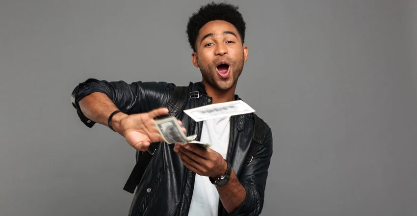 A creator fanning out cash in their hand after being paid.